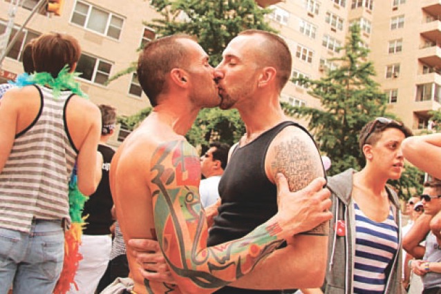 Men kissing at recent New York Gay Pride Parade, 2011. Photo by Eric Wolman