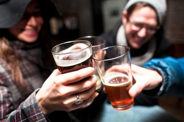 Revelers toast at One Stop Beer Shop.  Photo by Benjamin Lozovsky