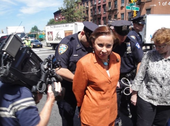 Congresswoman Nydia Velázquez is handcuffed by a New York Police Department officer on Hicks Street and Atlantic Avenue on Aug. 5, 2013. Velázquez intended to be arrested in protest of the closure of nearby Long Island City Hospital. (Sarah Matheson/Epoch Times)